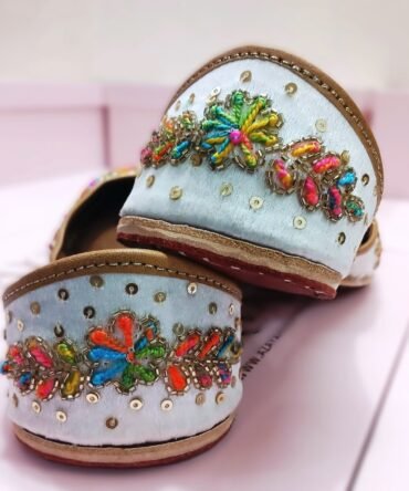 Bright satin jutti in pink, green, orange, and gold embroidery – handcrafted by Azayaa