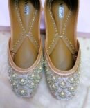 Front view of handcrafted Noorani Juttis by Azayaa with detailed bead and pearl work