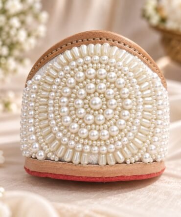 Close up of Ivory jutti with pearl hand embroidery