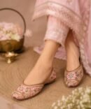 Pink Cherry Blossom juttis with floral embroidery and golden detailing by Azayaa