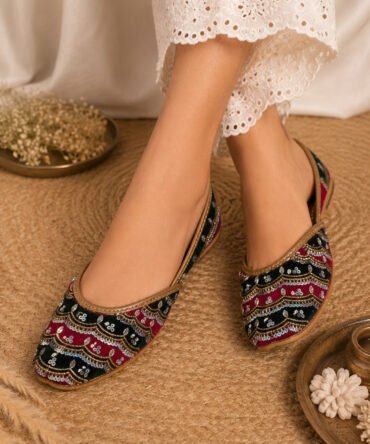Dastaan black and red embroidered juttis with sequin detailing by Azayaa