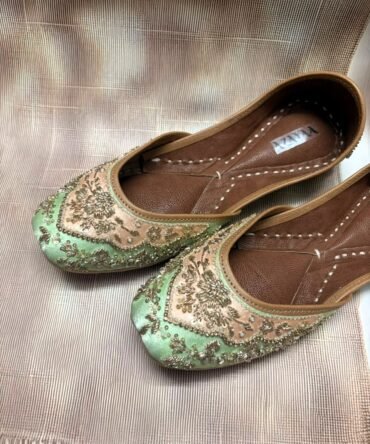 Handcrafted pastel green juttis with intricate floral detailing