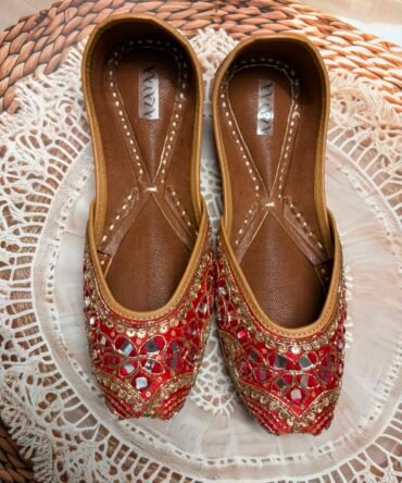 Heer red juttis with gold embroidery and mirror embellishments by Azayaa