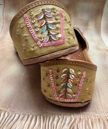 Close-up of colourful Rangrez Punjabi juttis with sequin detailing