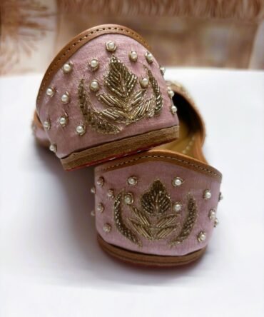 Close-up of pink Rose Mist juttis with intricate pearl embellishments