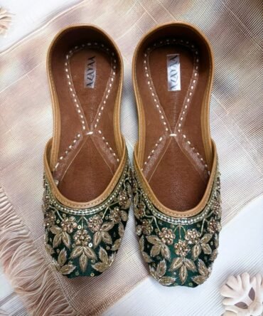 Shehzadi emerald green juttis with rich golden floral embroidery by Azayaa