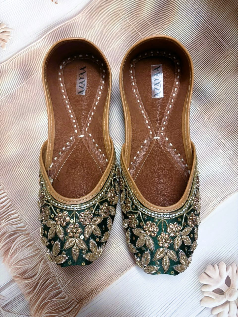Shehzadi emerald green juttis with rich golden floral embroidery by Azayaa