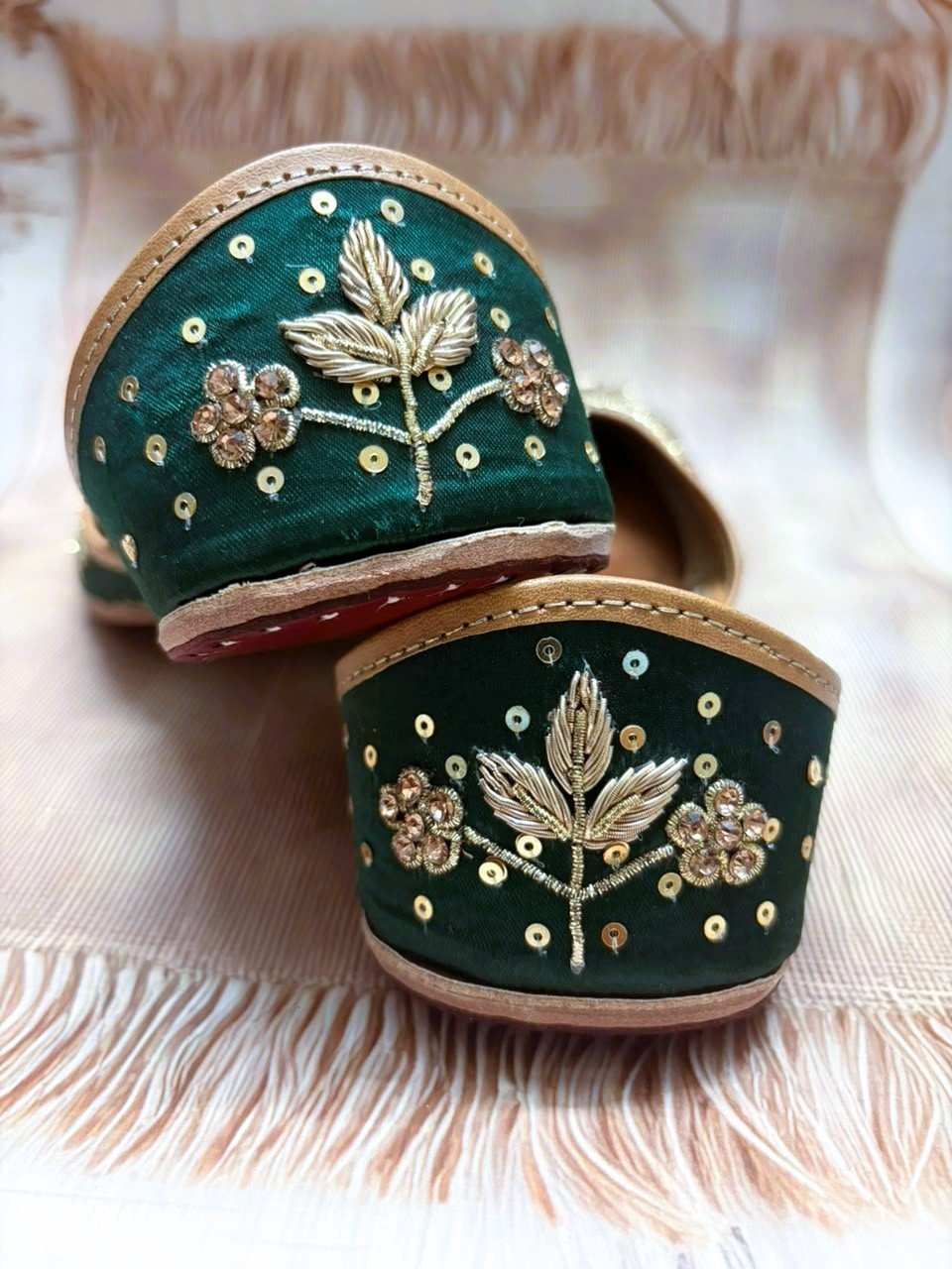 Close-up of green and gold Shehzadi Punjabi juttis