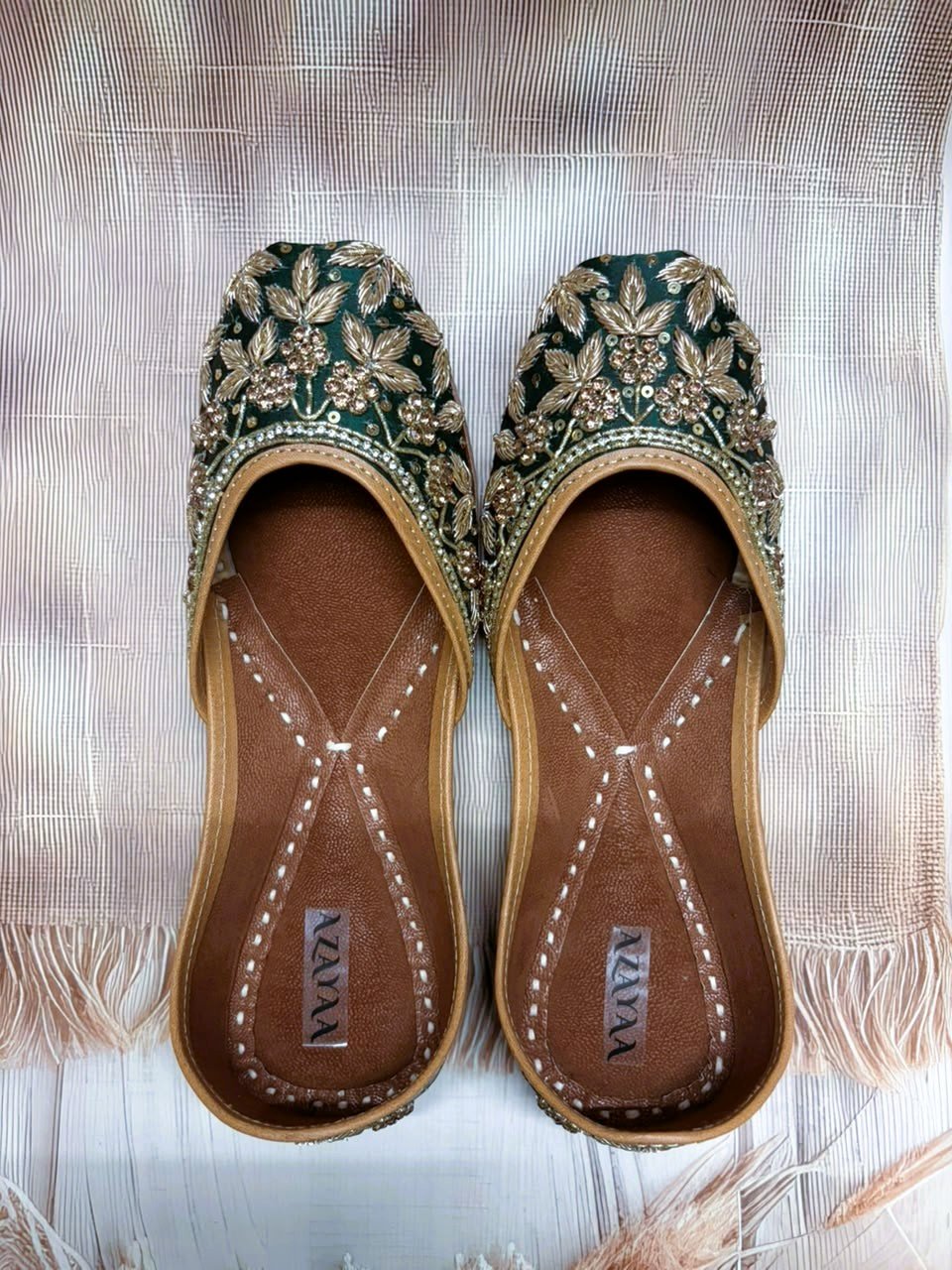 Handcrafted emerald green wedding juttis with golden embellishments